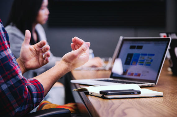 Stock photo of hands in front of a computer screen